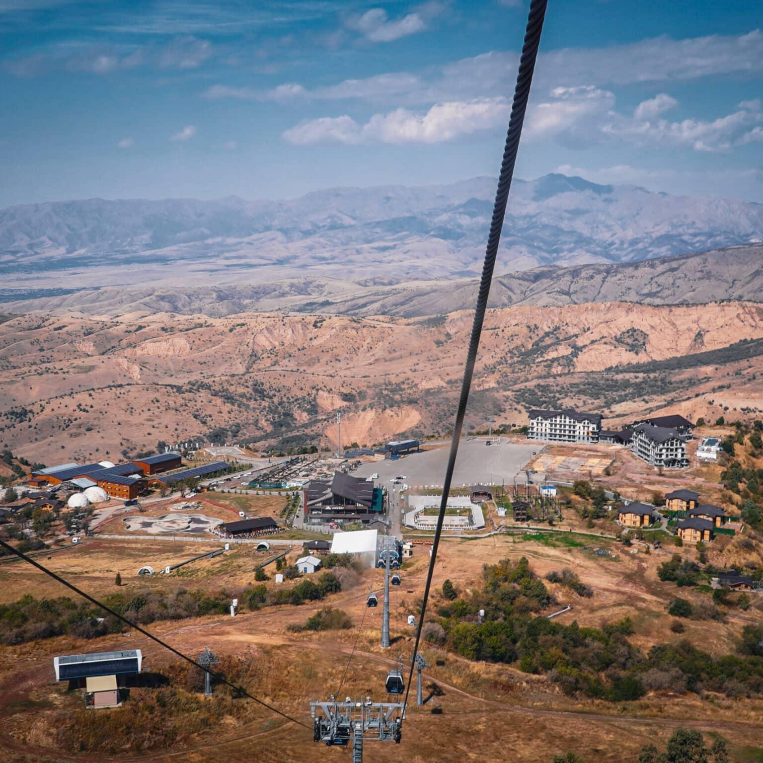 View of the mountains and the cable car from a gondola in the Chimgan Mountains of Uzbekistan