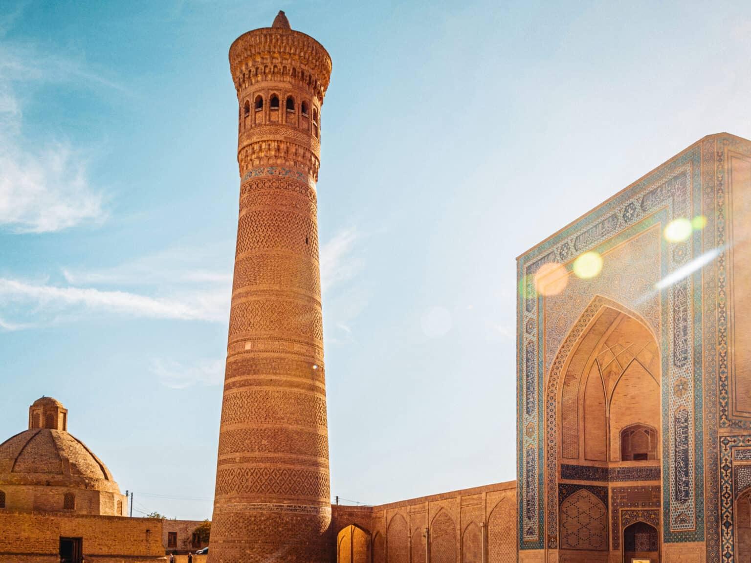 View of the impressive Kalon Minaret and the Kalon Mosque in Bukhara, illuminated by the sun
