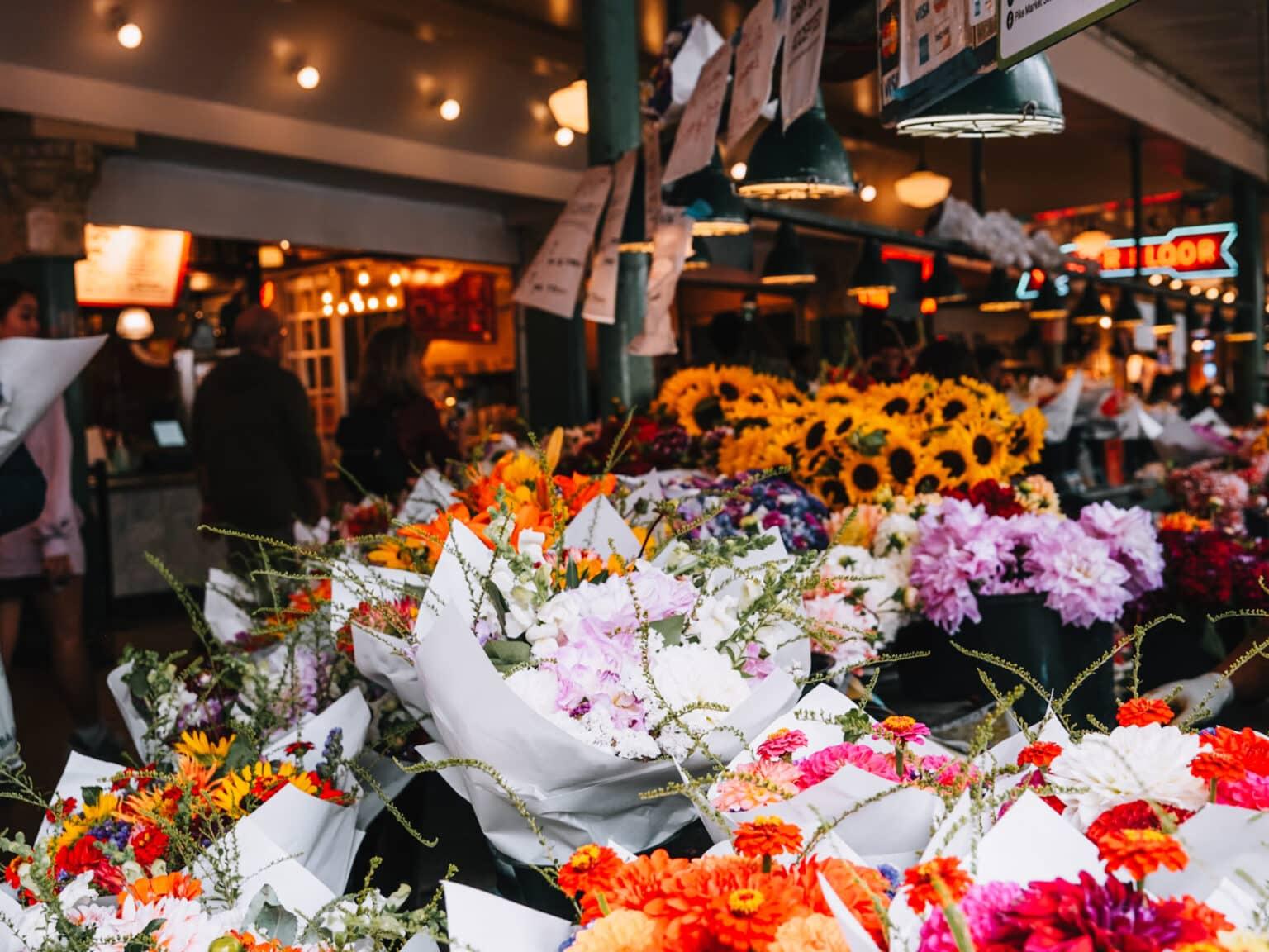 Many colorful flower bouquets at a market stall.
