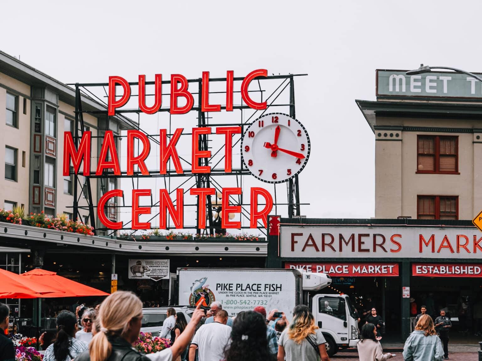 Some people approach the main entrance of Pike Place Market.