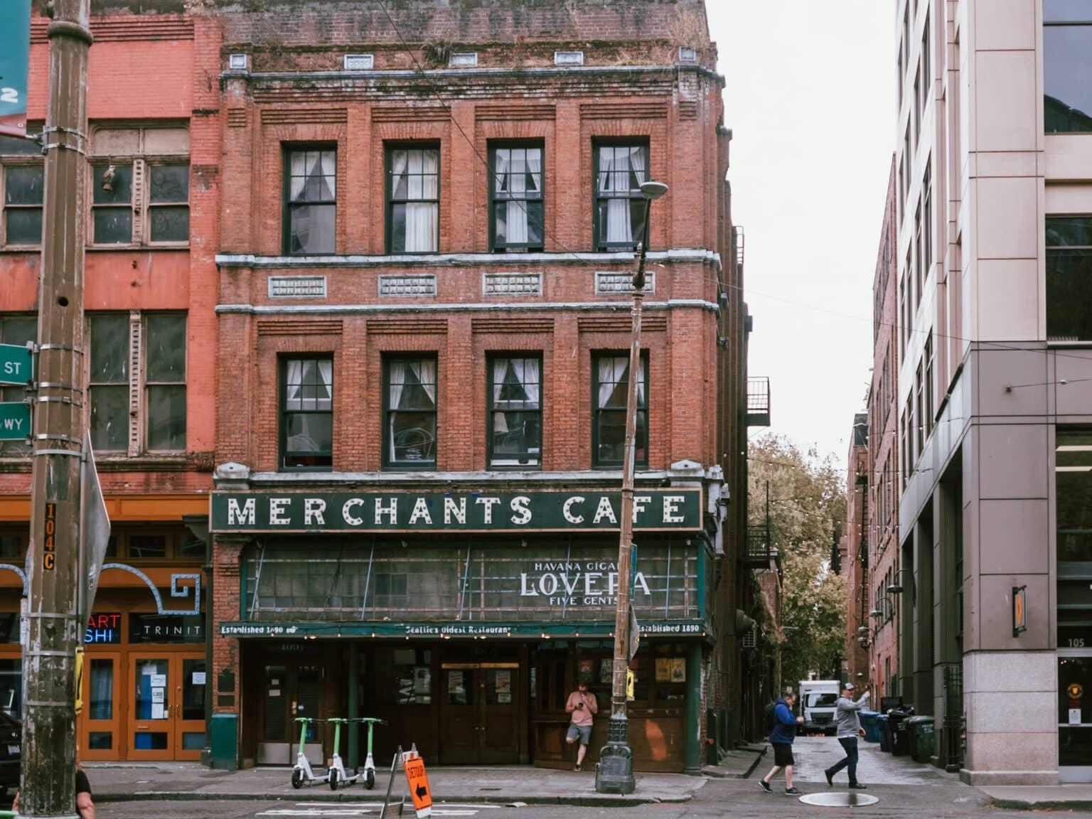 A historic red brick building in Pioneer Square with the inscription "MERCHANTS CAFE."