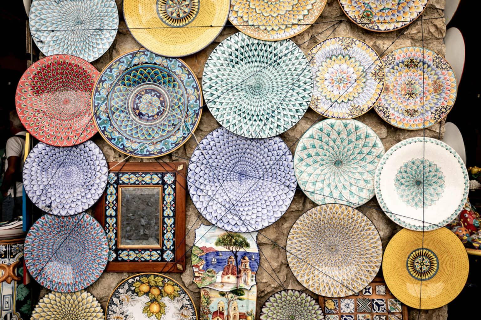 Colorful plates hanging on a wall.