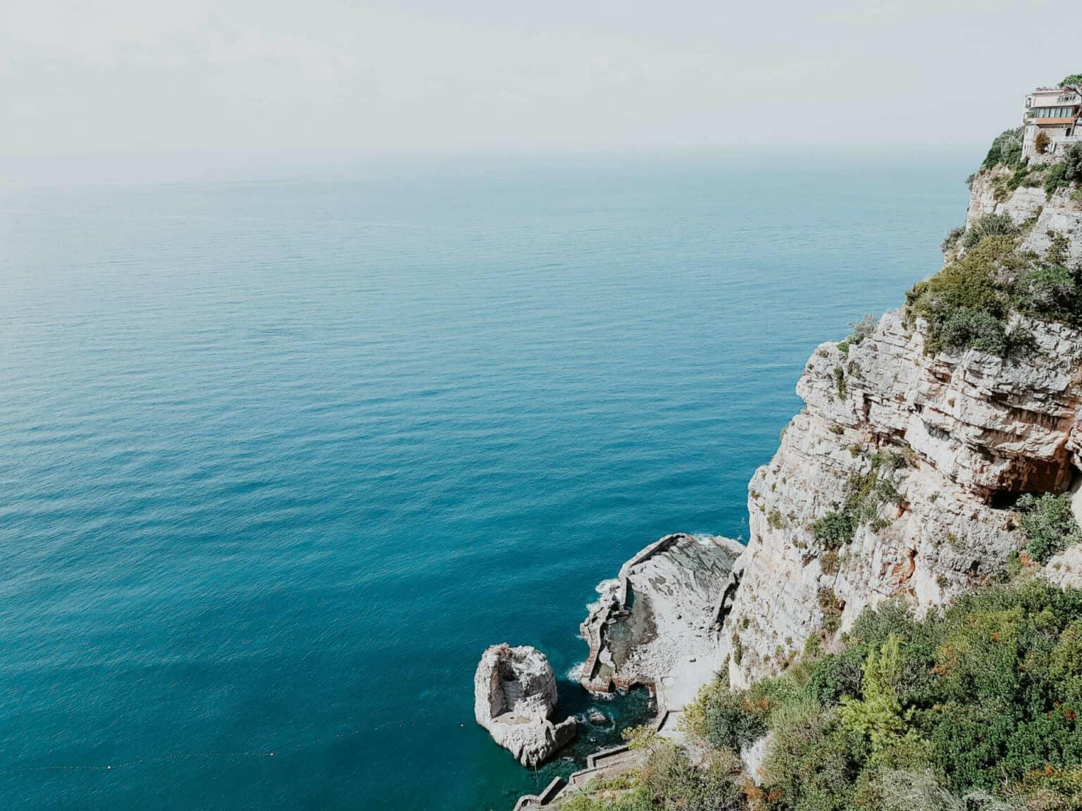 A rock wall by the sea.