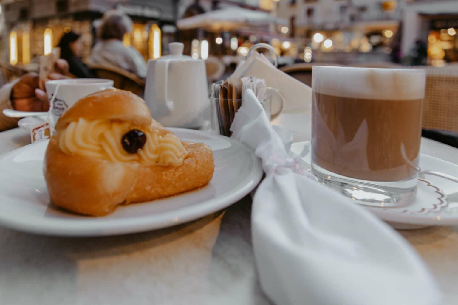 Pastry on a plate with coffee.