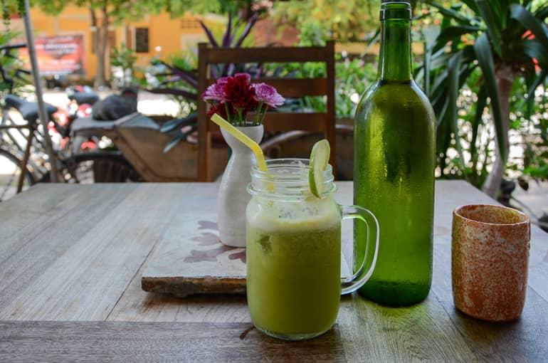 A green smoothie sits on a table in a cafe in Kampot, Cambodia.