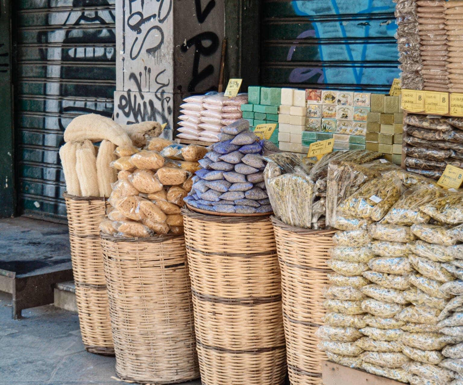 Exploring Athens: Freshly packaged spices and Greek specialties stacked up at a market.