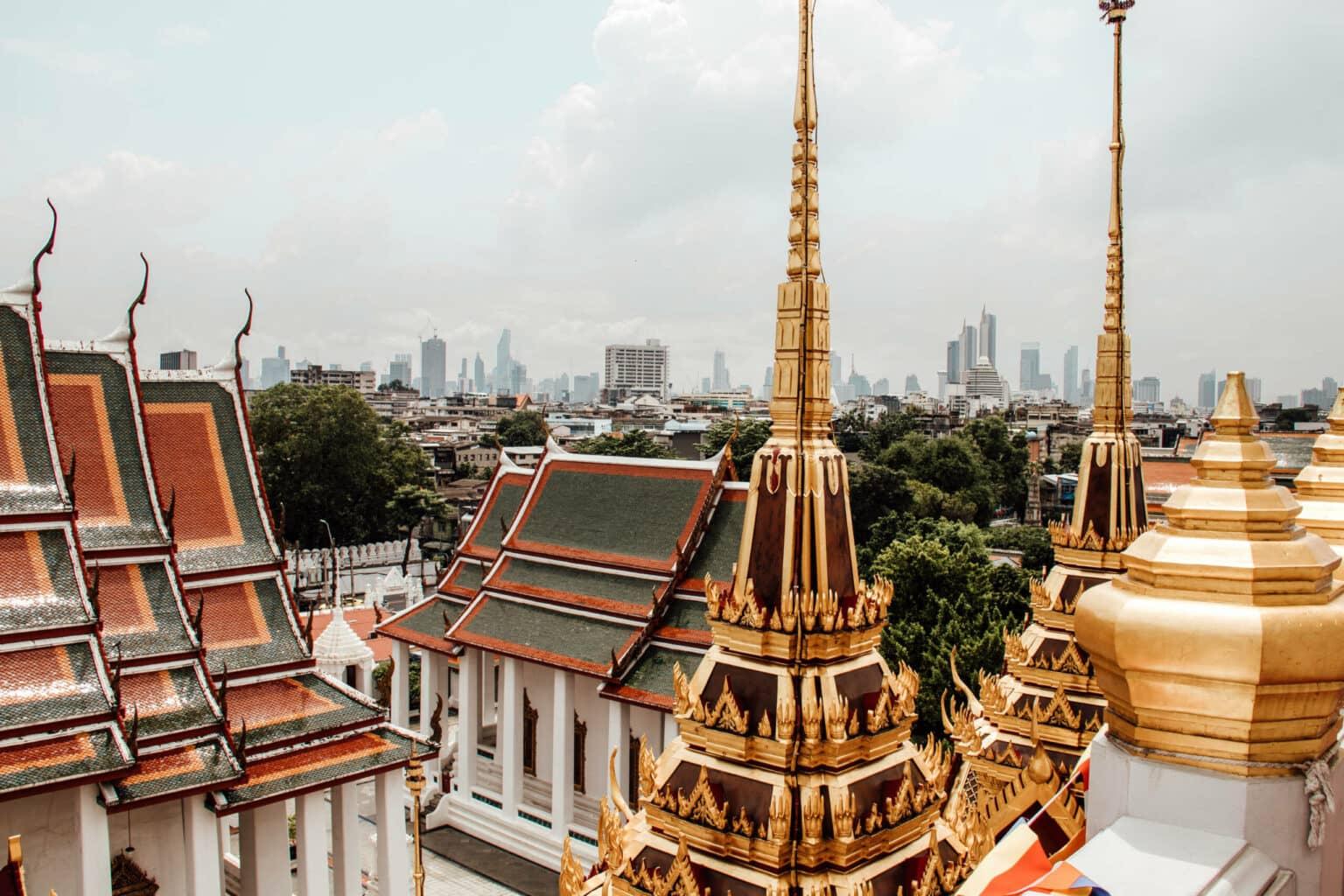 The gold-tipped spire of Wat Ratchanatda Palace amid Bangkok.