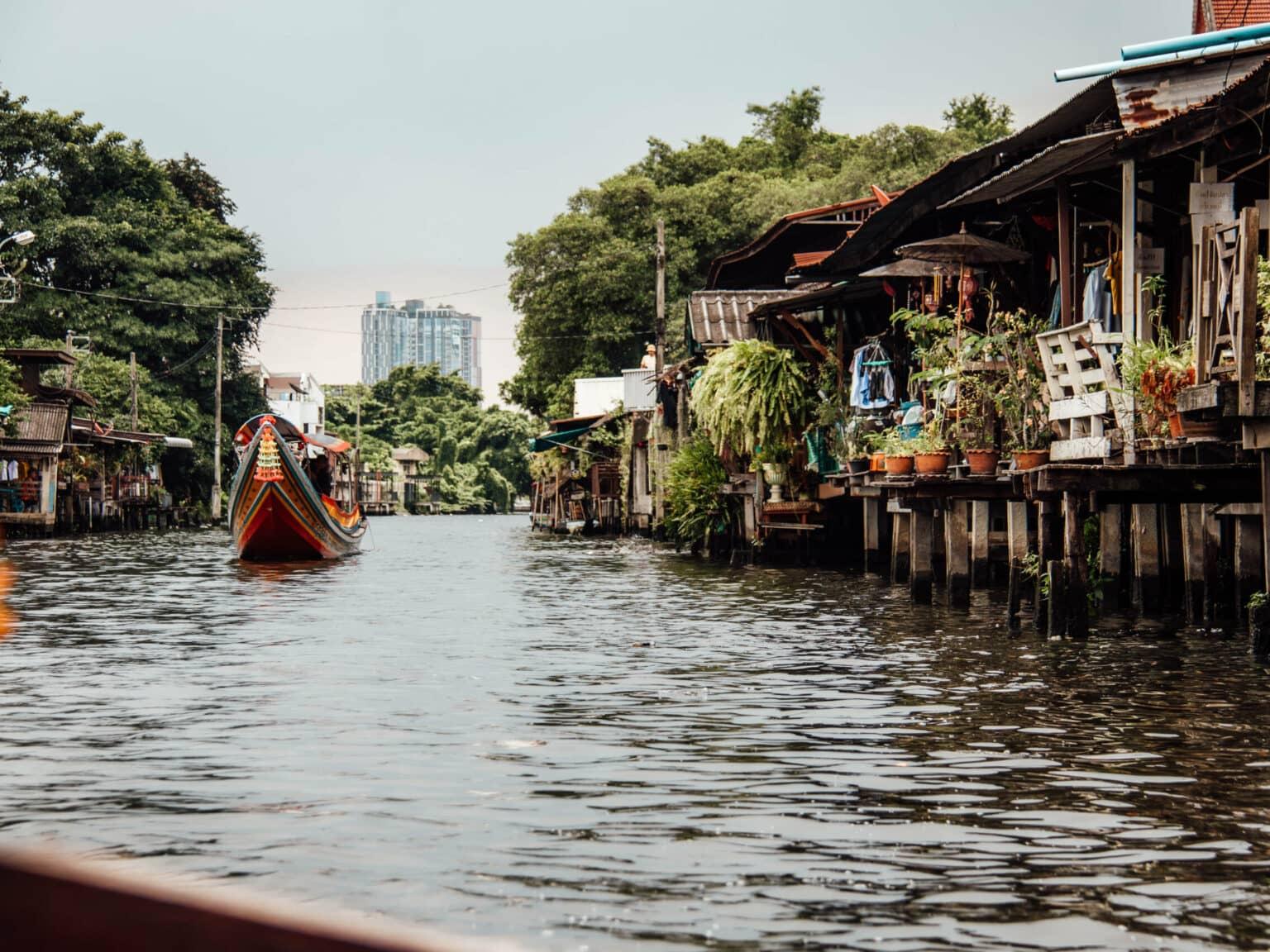 Residential houses along the waterways where longtail boats glide.