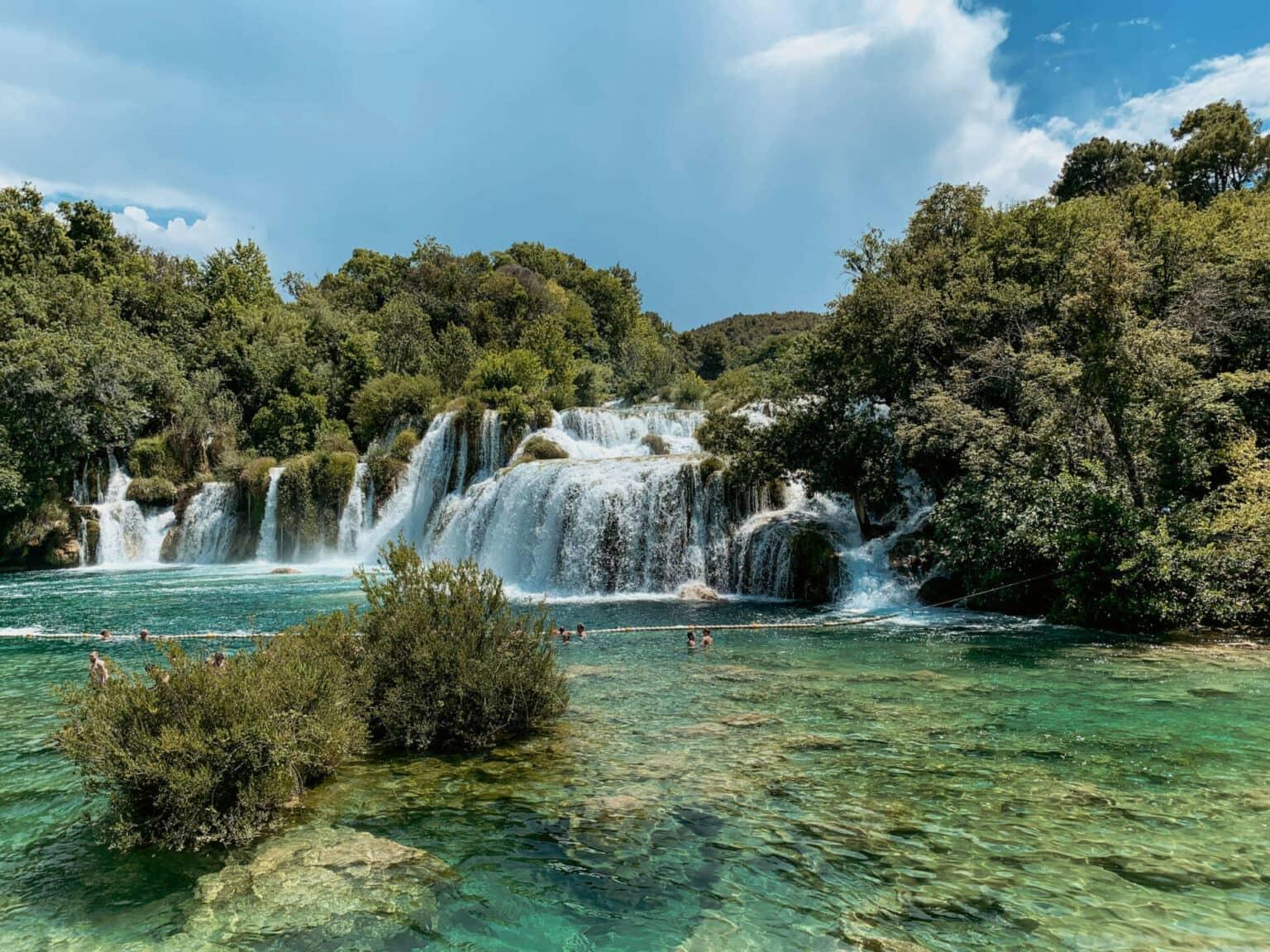 You have to make a stop on a road trip through Croatia: The impressive Skradinski Buk waterfall in Croatia. Visitors swim in the pools below the waterfall.