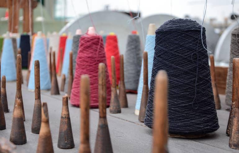 Colorful spools of thread on a table.