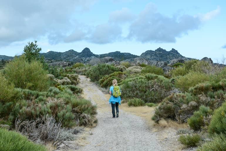 A woman walking along a path, seen from behind.