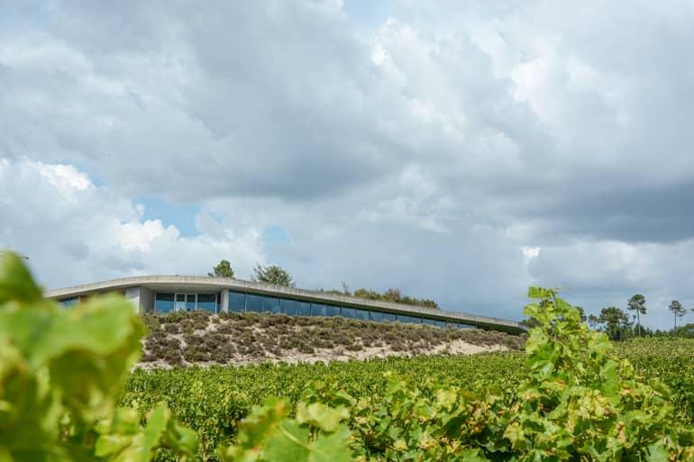 A modern house standing in a field.