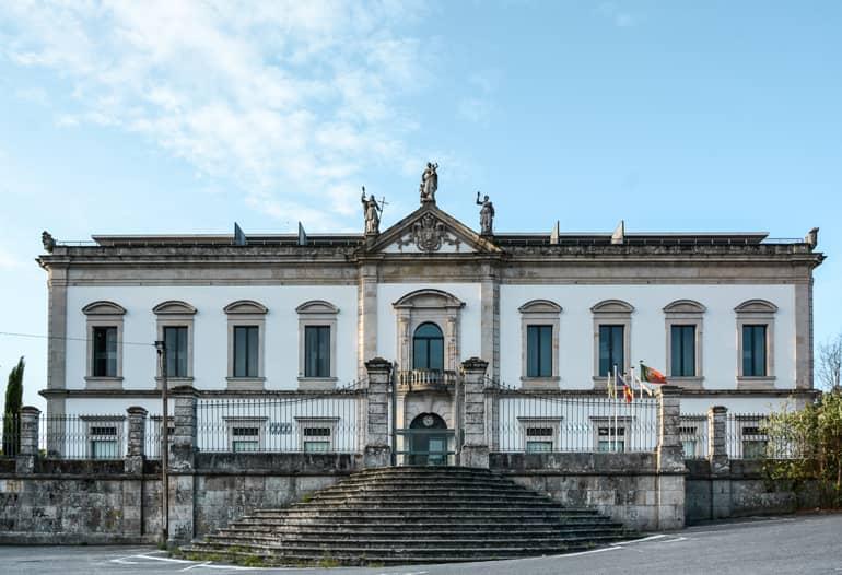 An old building with a large staircase in front.