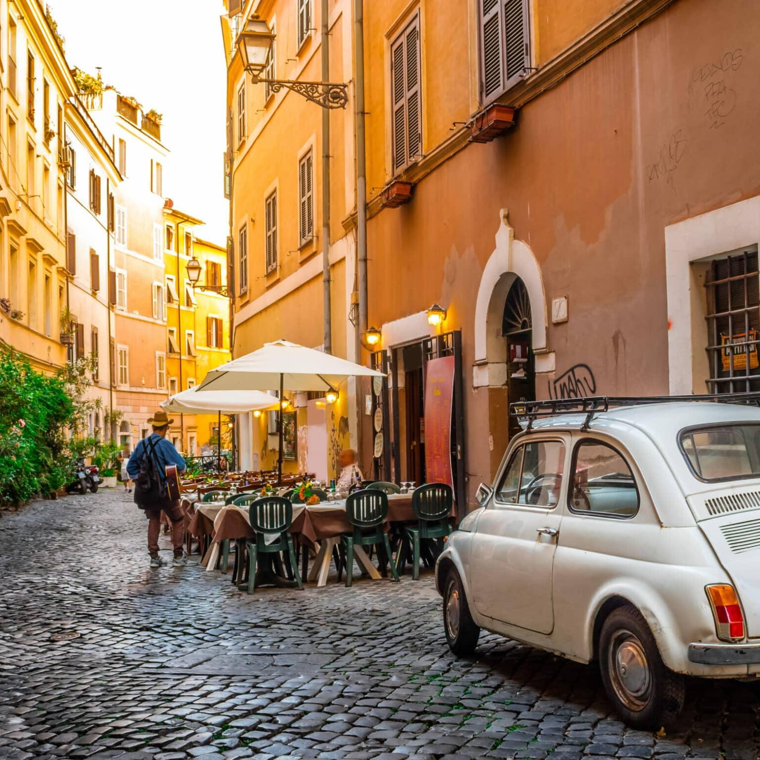 An old Fiat 500 parked in an alley of Rome's famous neighborhood Trastevere.