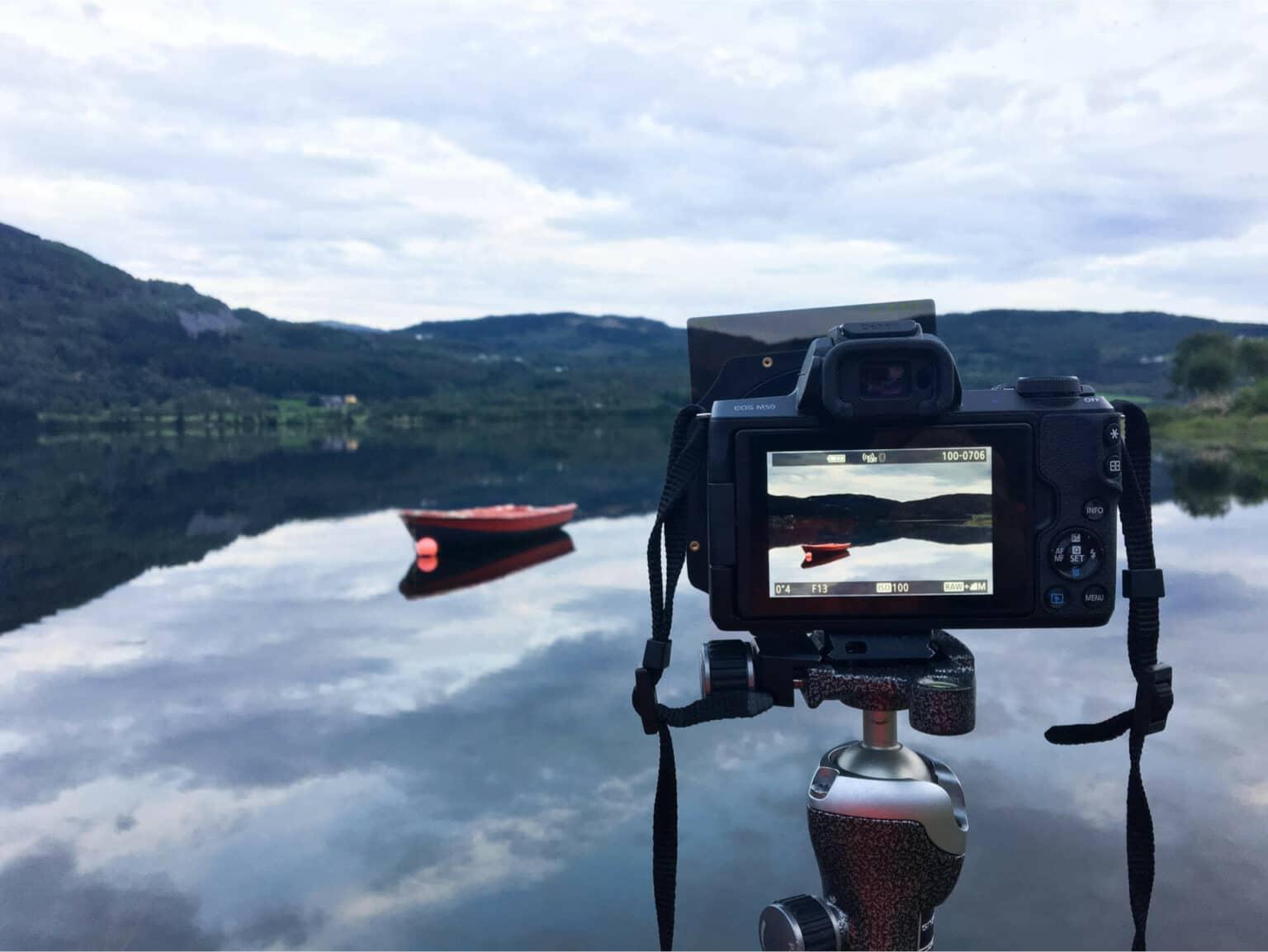 Travel photography with a beginner camera at a lake in Norway, with a boat floating on it.