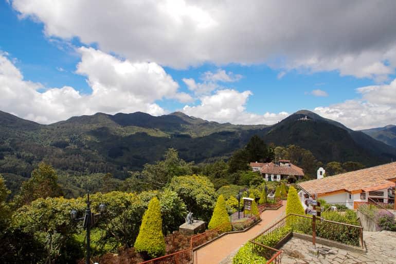 Despite the clouds, the sun shines on Colombia's Monserrate and its green-covered hills.