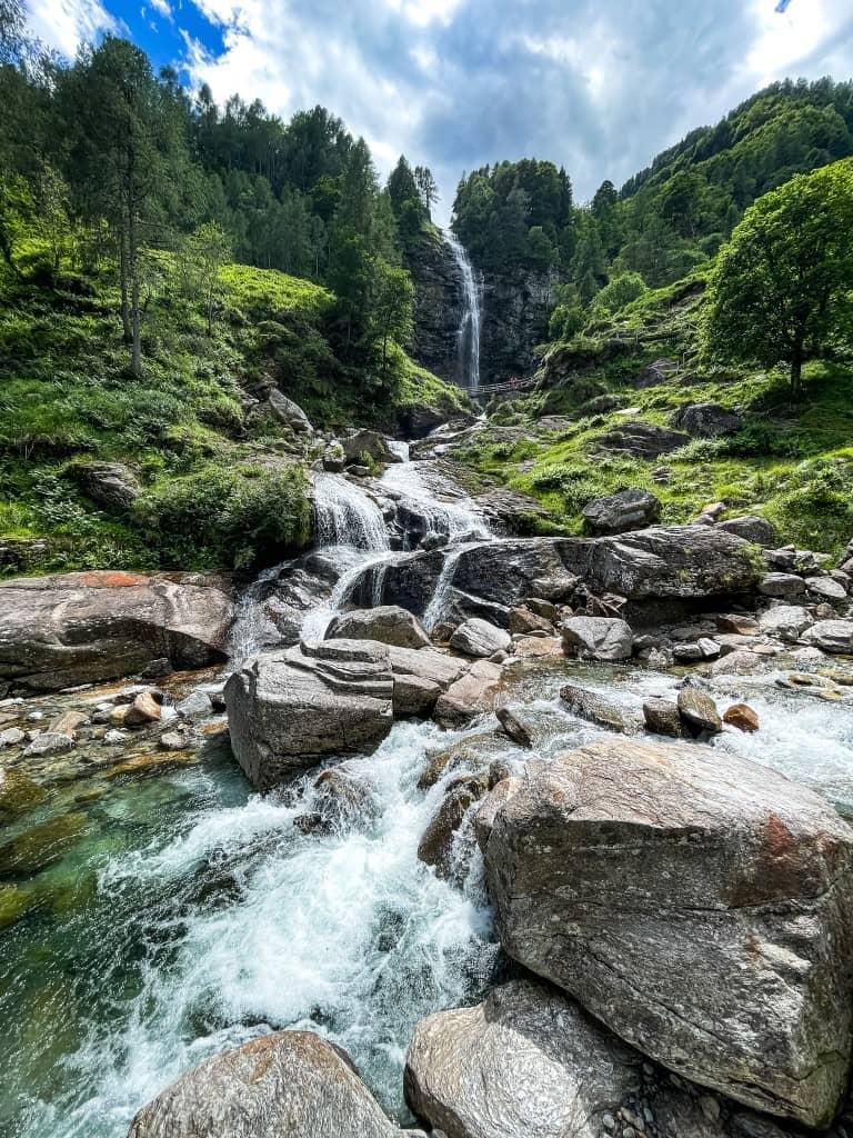 The Cascata La Froda is a beautiful waterfall that winds its way through trees and rocks.