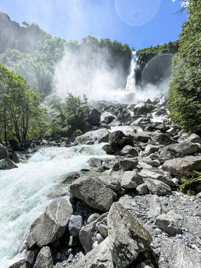 The Cascata di Foroglio is a roaring waterfall between trees and rocks.