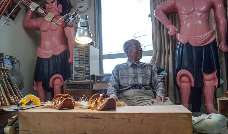 86-year-old Mr. Taba sits on a small chair at his desk creating handmade masks on the Yaeyama island of Ishigaki in Japan.