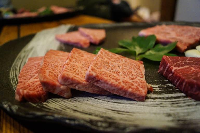 Thinly sliced raw Japanese beef for grilling is offered on a plate at the Ishigakiya restaurant on the Yaeyama island of Ishigaki.