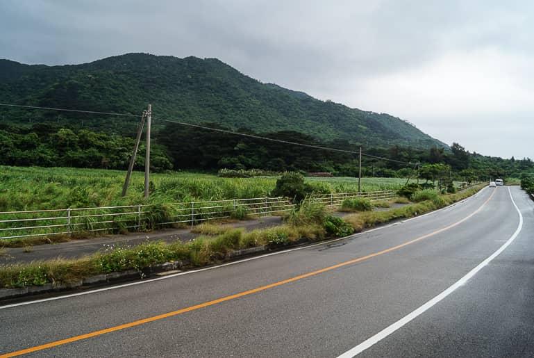 Dark green hills and meadows line the roads of Yaeyama's Ishigaki Island in Japan.