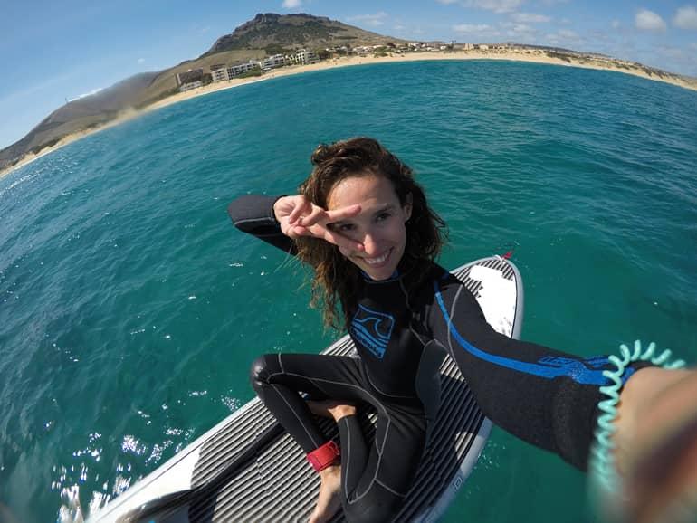 Madeira diving, surfing: A woman sits on a stand up paddle board.