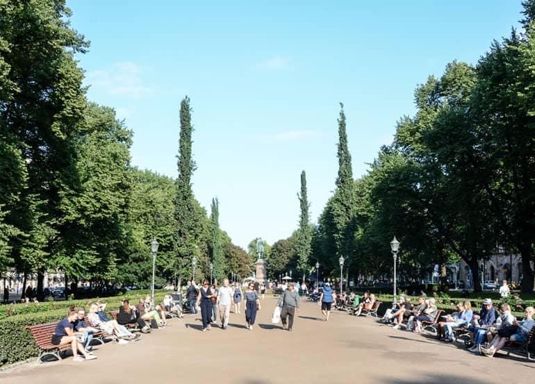 Helsinki: Wide road through a park with many people.