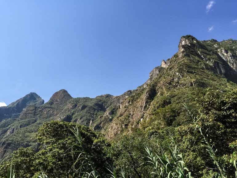 The last hiking stretch to Aguas Calientes offers a view of Machu Picchu and its green-covered mountains.