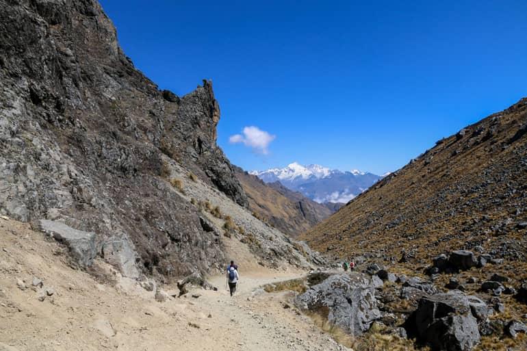 The hiking trail on the Salkantay Trek in Peru leads through rocky mountain gaps.