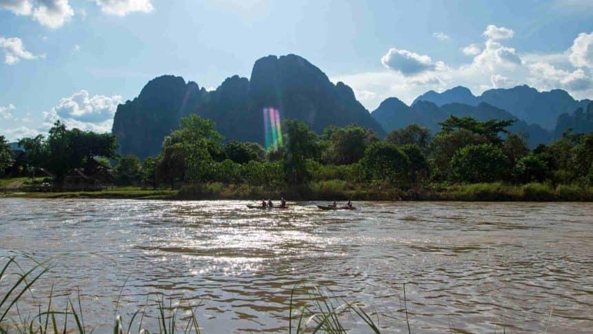 On the Nam Song River, paddling in a kayak surrounded by green nature as the sun sets is a fantastic experience.