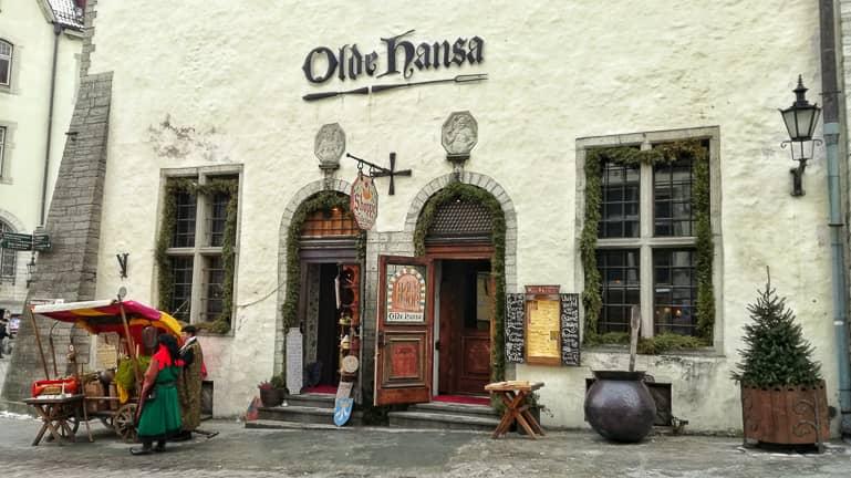 In front of the medieval facade of the Olde Hansa restaurant in Tallinn stands a medieval market stall.