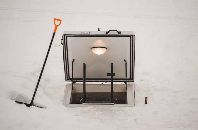Ice hole in a frozen lake in Finnish Lapland.