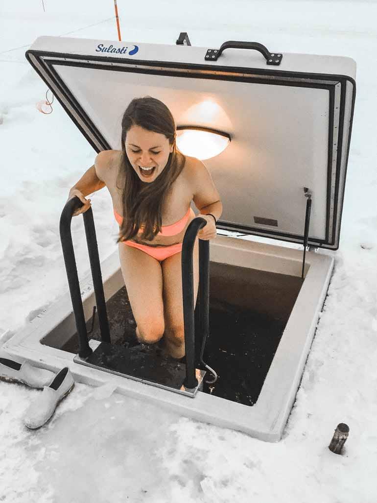 A woman ice bathing in Finnish Lapland