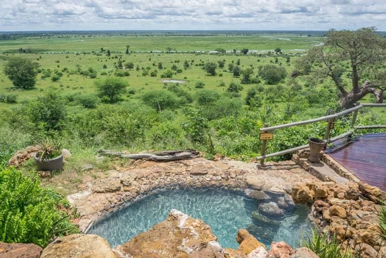 A pool raised high above with a stunning view of Chobe National Park's landscape in Botswana.