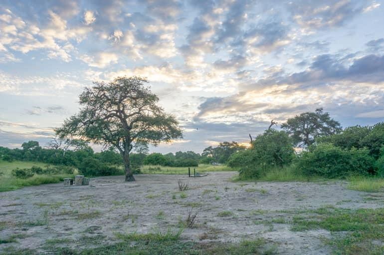 The sun sets over the landscape of the Savuti Campsite grounds in Chobe National Park.