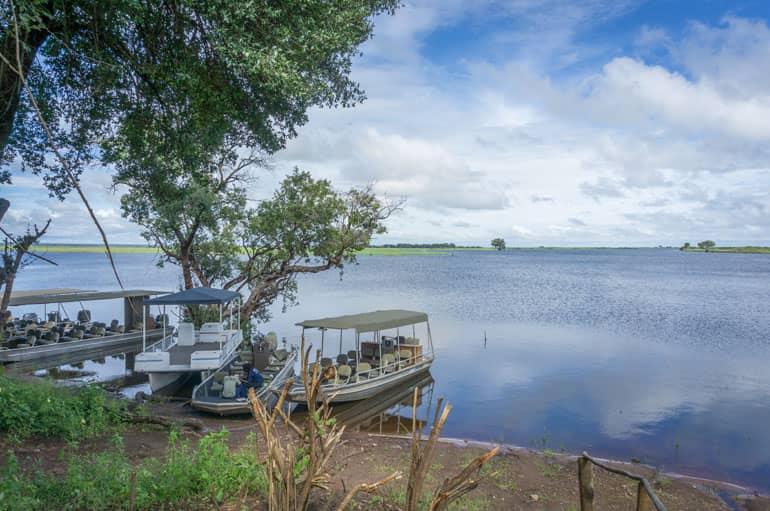 View of the dock on the Chobe River with five boats.